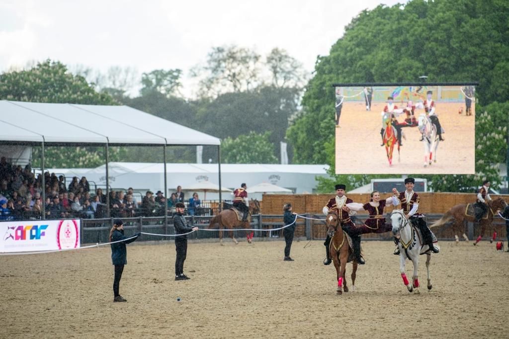 Azerbaijani horsemen wave national flag at Windsor Royal Equestrian Show in UK